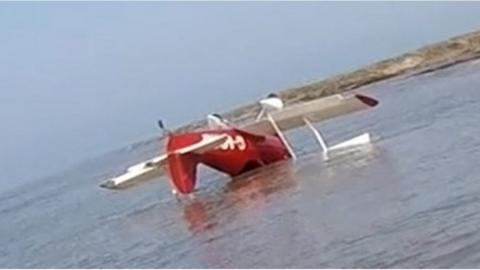 An airplane upside down in water