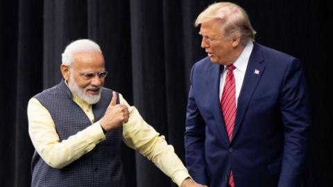 US President Donald Trump and Indian Prime Minister Narendra Modi attend "Howdy, Modi!" at NRG Stadium in Houston, Texas, September 22, 2019. Tens of thousands of Indian-Americans converged on Houston on Sunday for an unusual joint rally by Donald Trump and Narendra Modi, a visible symbol of the bond between the nationalist-minded leaders. With many in the crowd decked out in formal Indian attire or the signature saffron of Modi's Bharatiya Janata Party, the event kicked off in a football stadium with a Sikh blessing, boisterous bhangra dancing and, in a nod to local customs, cheerleaders in cowboy hats. (Photo by SAUL LOEB / AFP) (Photo by SAUL LOEB/AFP via Getty Images)