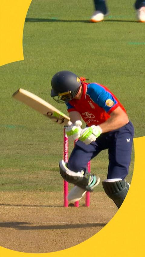 Jos Buttler looks back to the stumps while holding his bat as he bowled by India in the T20.