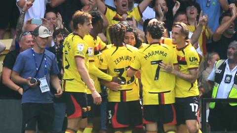 Watford players celebrate in front of fans