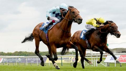 Oisin Murphy riding Starman (L, light blue) win The Duke Of York Clipper Logistics Stakes at York Racecourse on May 12, 2021 in York, England.
