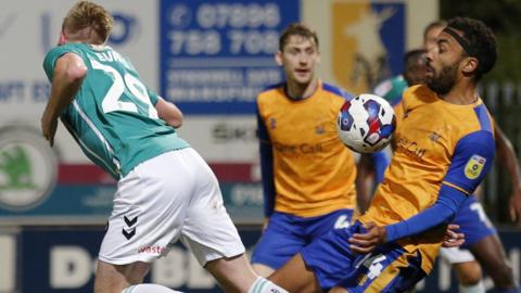 Will Evans in action against Mansfield's James Perch