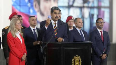 A handout photo made available by Prensa Miraflores of Venezuelan President Nicolas Maduro (C) speaking during a press conference at the Supreme Court of Justice in Caracas, Venezuela, 09 August 2024