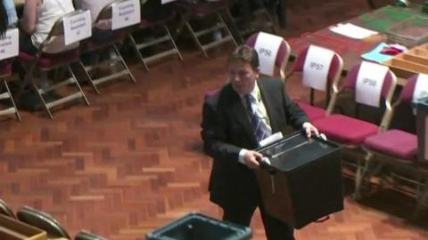 Man carrying ballot box