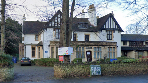 A photo of The Lindens taken from the road, in 2021, showing a mock Tudor-style white house with dark roof.