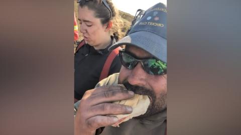 Firefighter tucks into a ham sandwich