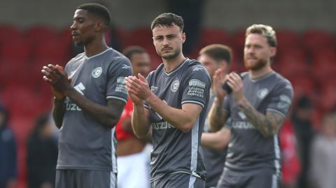 MK Dons applaud their fans after the draw at Fleetwood