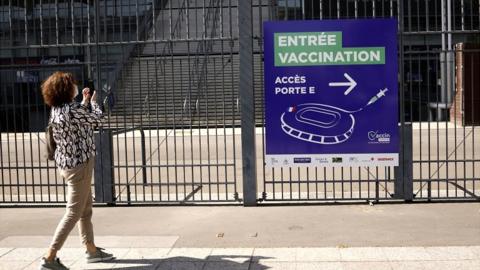 Signs of the entrance of a Covid-19 vaccination centre are installed outside France's national stadium, Stade de France, near Paris, France, on 31 March 2021