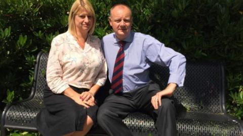 Tracey and Andrew Buckett sitting on a bench