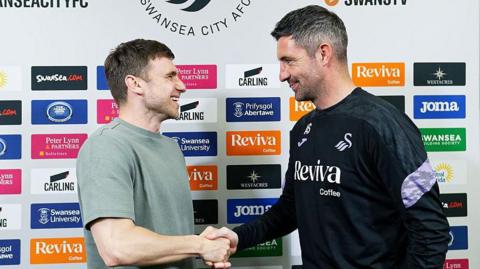 Richard Montague shakes hands with Alan Sheehan