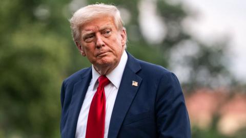 US President Donald Trump walks on the South Lawn of the White House after arriving on Marine One in Washington, DC, US, on Sunday, July 13, 2025