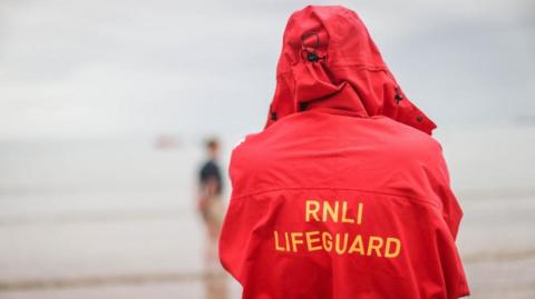 Beach lifeguard looks out to sea