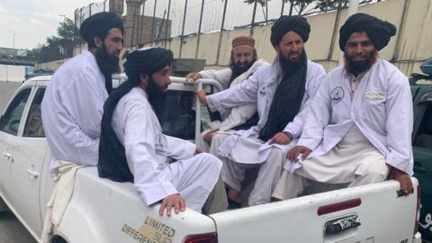 Maulvi Fatih and his officials use a pick up truck to get around