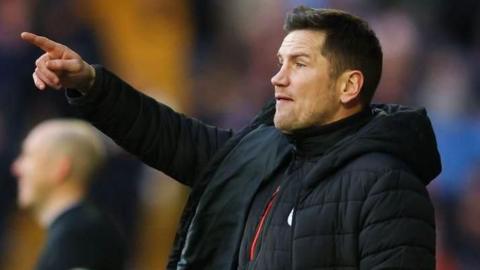 Crewe Alexandra manager Lee Bell stands on the touchline in his club puffer coat pointing and shouting instructions Copyright