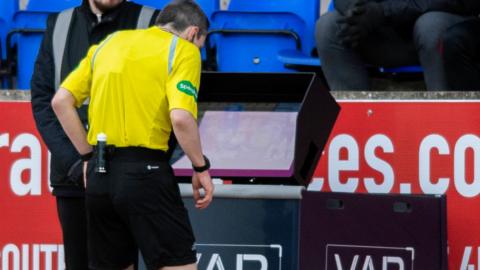 Referee Craig Napier checks VAR for a red card challenge from St Johnstone's Daniel Phillips during a cinch Premiership match between St Johnstone and St Mirren at McDiarmid Park,