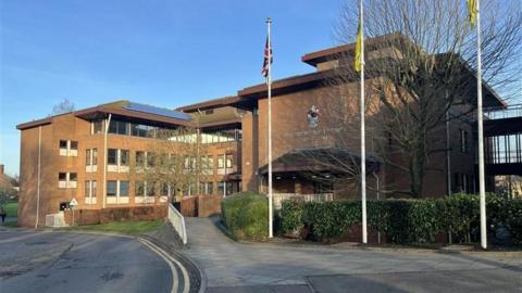 A three-storey red brick building.