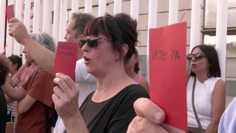 Protesters holding red cards