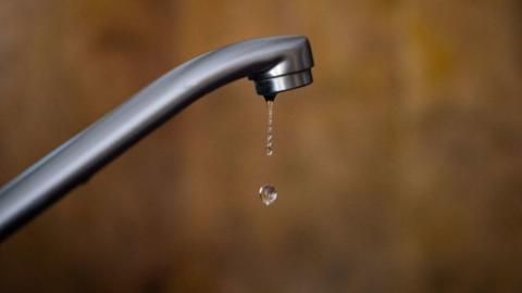 a drop of water sinking from a tap.