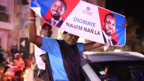 People gather to celebrate the release of Senegal's top opposition leader Ousmane Sonko and his ally and the presidential candidate Bassirou Diomaye Faye outside Cap Manuel prison and house the house of Sonko ahead of elections in Dakar, Senegal on March 14, 2024.