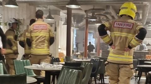 Firefighters in a flooded restaurant