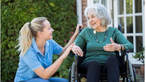 Healthcare assistant with elderly care home resident