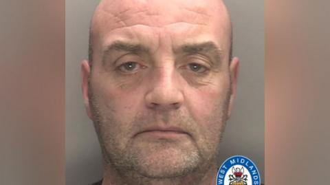 A police mugshot shows a man with a shaved head and stubble. There is a West Midlands Police logo in the bottom right of the image.