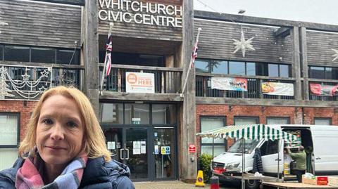 Helen Morgan stands outside Whitchurch Centre with a market stall in the background