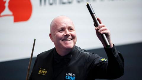 John Higgins celebrates