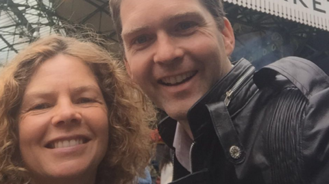 A close-up of Tom Morgan and his sister smiling into the camera