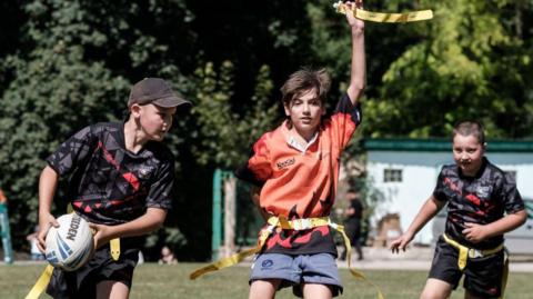 Children compete for the ball during Ukrainian Children's Tag Rugby League game