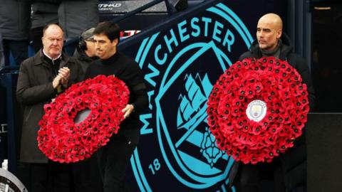 Andoni Iraola, manager of AFC Bournemouth, and Pep Guardiola, Manager of Manchester City, hold poppy wreaths on November 04, 2023 in Manchester, England