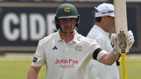 Liam Patterson-White raises his bat to the crowd