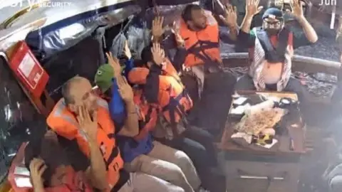A photo purportedly showing activists with their hands up on board the Madleen ship