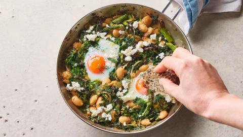 Green baked eggs with butter beans.