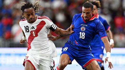 Peru's Andre Carrillo and Haiti's Wilson Isidor