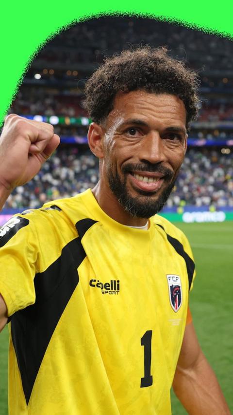 Cape Verde goalkeeper Vozinha celebrating his team progressing to the World Cup knockouts. He is wearing a yellow Cape Verde goalkeeper kit.