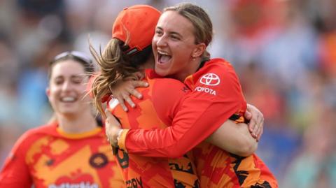 Hannah Baker hugs a team-mate