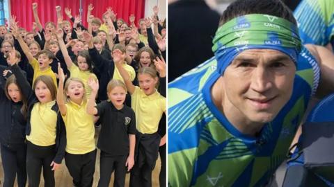 The image is split into two sections. On the left, a large group of schoolchildren wearing yellow and black uniforms stand indoors in front of a bright red curtain, raising their hands enthusiastically. On the right, a close-up of Kevin Sinfield wearing a blue and green patterned athletic shirt and a green headband.