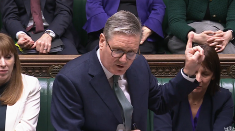 Starmer points his finger as he speaks at the dispatch box - to his left is Angela Rayner and his right is Rachel Reeves