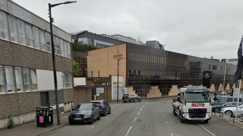 A google view of Milton Street, with three cars parked outside offices and a lorry parked outside a Mercedes showroom