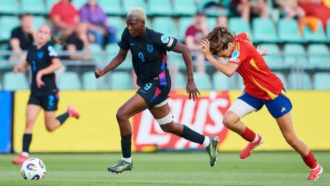 Princess Ademiluyi of England fights for the ball 