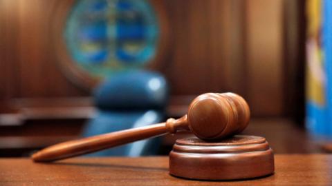 A brown gavel on a desk.