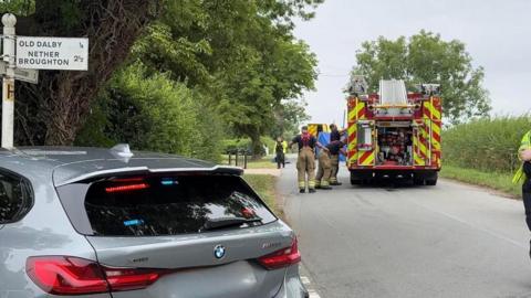 Emergency services at the scene of a crash on a rural road