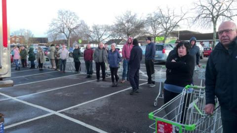 People queue for bottled water