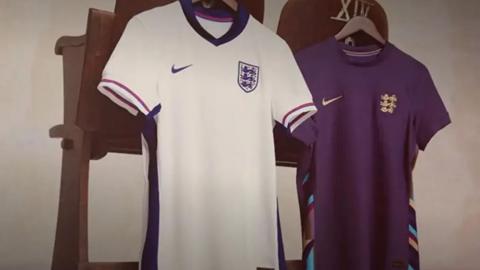 Two England football shirts hung up