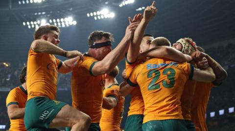 Australia players celebrate their winning try against England