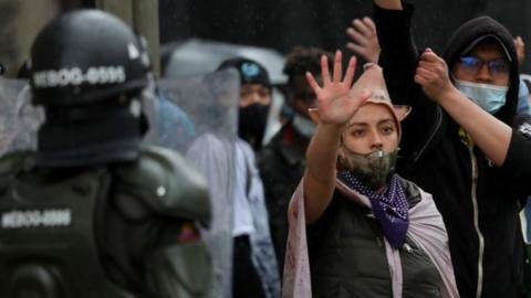 People gesture during a protest against the tax reform of President Ivan Duque"s government in Bogota, Colombia, May 1, 2021.