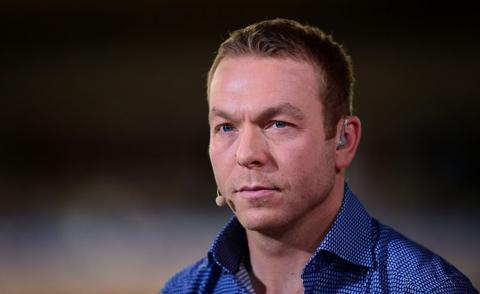 Sir Chris Hoy wearing a headset microphone, angled to the right and looking at an angle past the camera. The top part of his blue and white dotted shirt can be seen