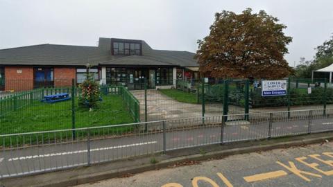 Lower Darwen Primary School in Blackburn, a single storey red brick building with large grassed areas to the front