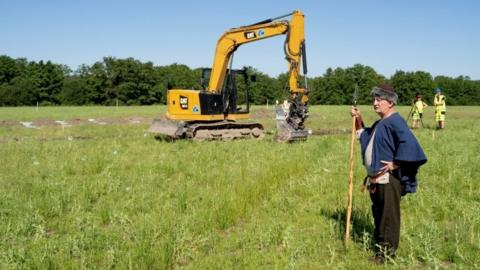 Man dressed as Viking at excavation site